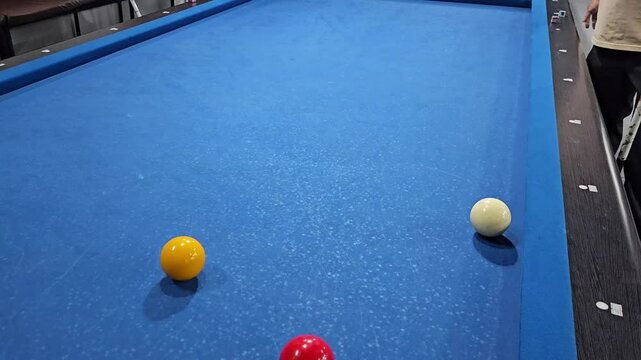 People playing carom 3 cushion billiard games, known as French billiards, it consists of three balls and a table without holes.