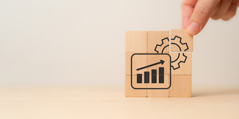 Business growth strategy, continuous improvement, productivity. Wooden blocks forming an image of a...