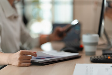 Businesswoman working with data spreadsheet documents at workplace