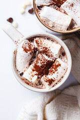 Winter hot chocolate with marshmallows in mug on white background. Christmas drink concept.