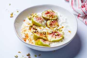 Breakfast cottage cheese with figs and maple syrup.