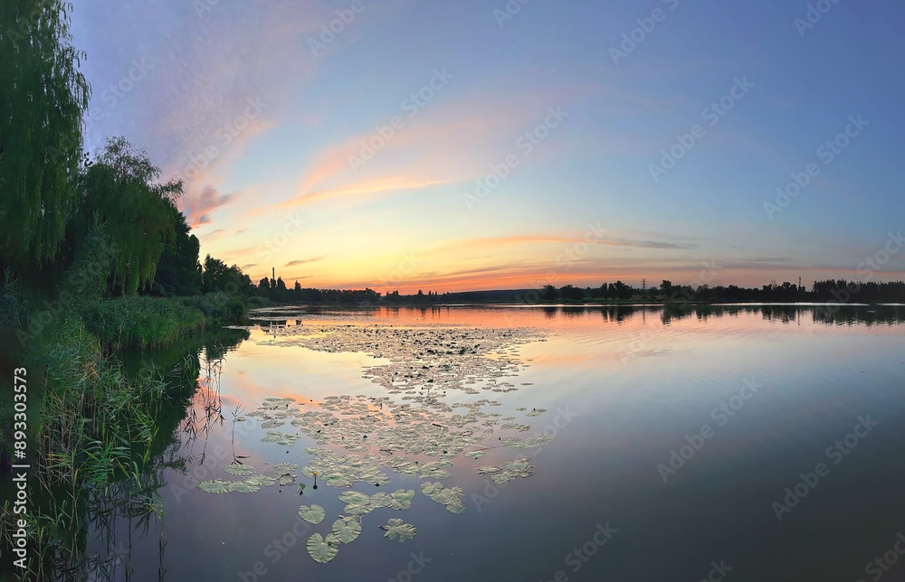 Wall mural lake with smooth water at sunset