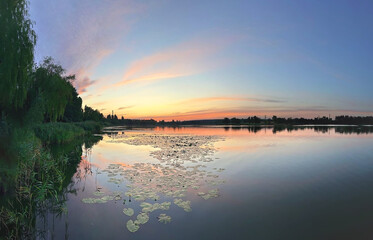 Lake with smooth water at sunset