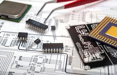 Electronic components and tools on an engineering blueprint for circuit board design.