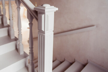Classic White Staircase Railing Detail. A close-up of a classic white staircase railing with...