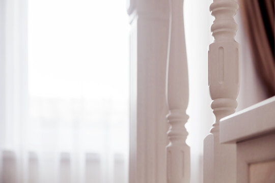 Detailed White Stair Spindle Close-Up. A close-up view of a white staircase spindle with intricate design details.