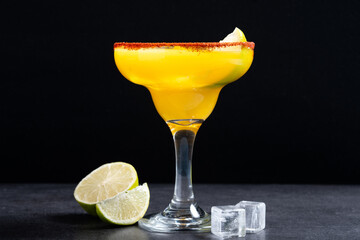 Fresh mango cocktail. Mexican mango cocktail on black slate background