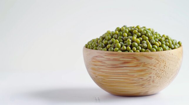A wooden bowl filled with vibrant green mung beans