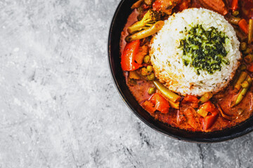 vegetable curry with rice dome in the middle topped with coriander