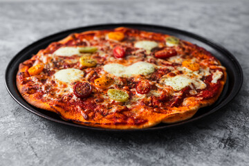 margherita pizza with cherry tomatoes and heart shaped cheese in the middle