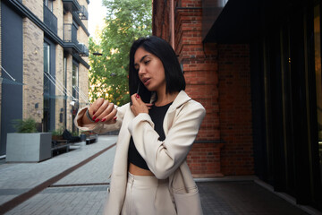 business woman in a suit works during rush hour. a young girl hurries to a meeting. young entrepreneur. freelancer. successful business