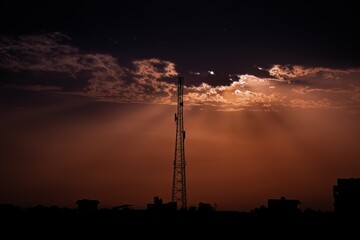 beautiful sunset with trees, clouds and tower