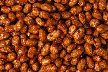 Tasty sweet roasted peanuts as a background.