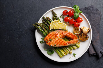 Grilled salmon steak over grilled asparagus, a delicious and healthy meal