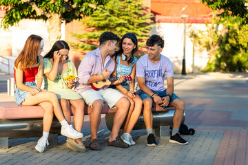 Fototapeta premium Group of friends enjoying time together outdoors, smiling and laughing