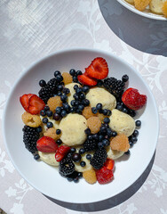 Lazy vareniki with seasonal berries in a white plate