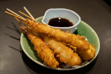 Kushiage is a Japanese dish of deep-fried skewered meat and vegetables.