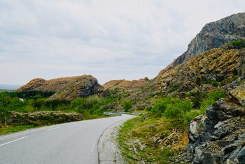 Road on the island of Leka surrounded by unique rock formations. Leka is designated as Norway's...