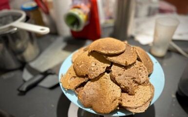 Close-Up of a Plate Full of Homemade Protein Pancakes Made with Whey, Oats, Eggs, and Chocolate on a Kitchen Counter