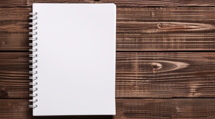 Open blank spiral notebook on a wooden desk, ready for notes, sketches, or ideas. Perfect for school, office, or personal use.