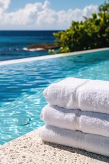 white folded towels on the background of the pool and the beach. selective focus