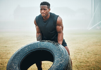 Nature, fitness and man with tire for workout with strength, muscles and body building training....