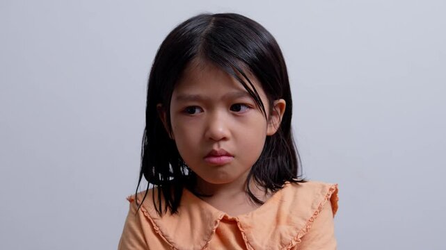 A Litter Asian girl sitting in room conner and crying after Punished by the blackout.