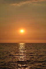 Golden sun setting, casting warm hues across the sky.