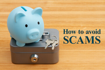 Avoid scams and protecting your money with a blue piggy bank safety lockbox with keys on a desk