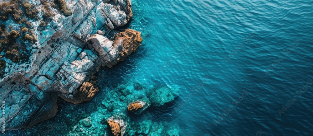 Poster aerial view of the ocean and stone with a scenic seascape as the backdrop showcasing various tones o