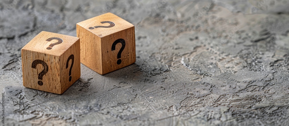 Aufkleber Three wooden cubes with question marks on a grey background with a copy space image