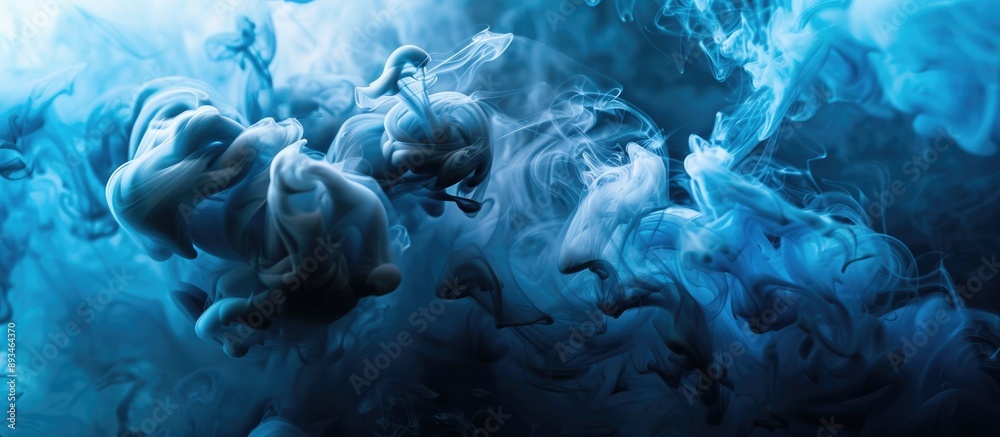 Poster Blue and black ink swirling in water, creating a colored abstract smoke explosion effect. Perfect for an abstract background with copy space image.