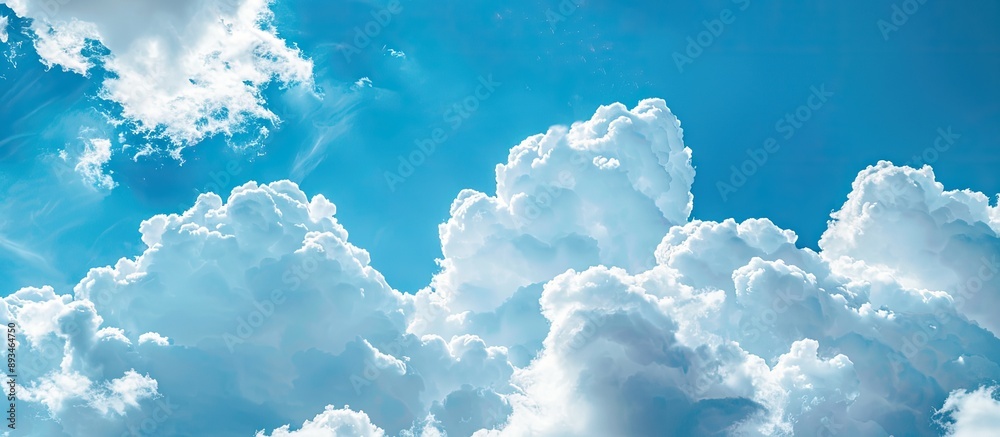 Poster white clouds on a blue sky with copy space image, representing nature and conservation themes.