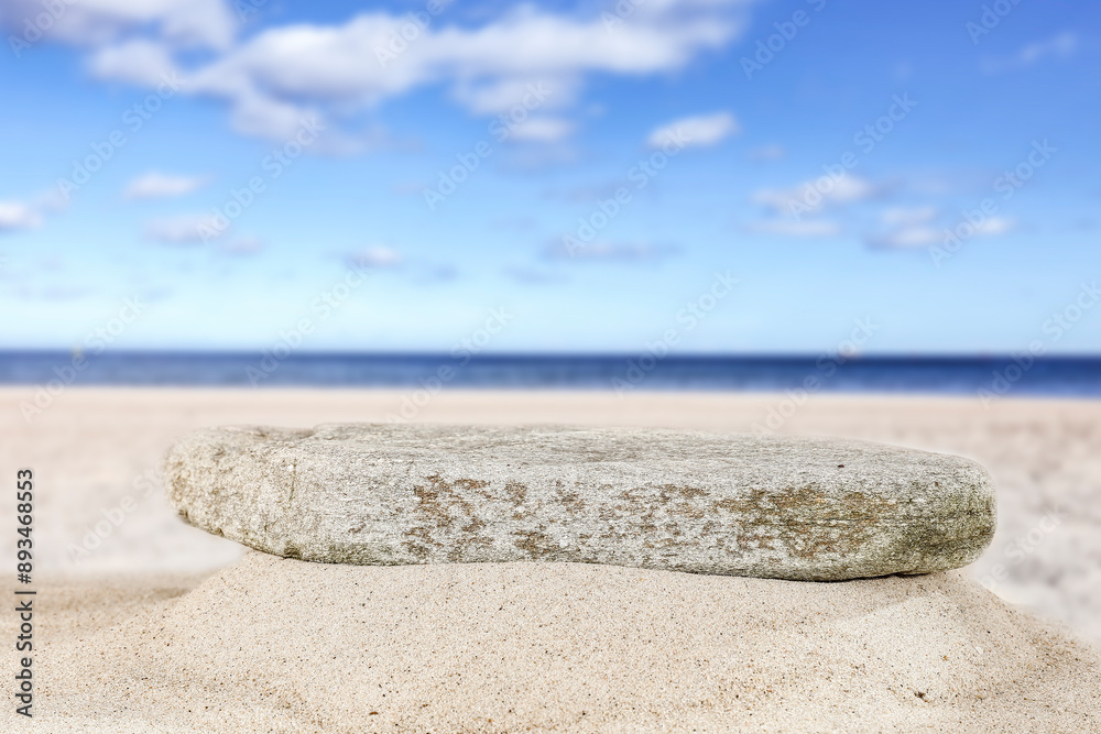 Sticker empty flat marble stone on sand on the baech. seascape background. copy space for products.