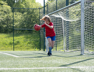 Girl Goalkeeper Tries To Catch Ball In Children'S Football Match