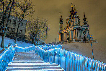 Wooden snow covered stairs, St. Andrew's Church. Evening. Winter. Kyiv