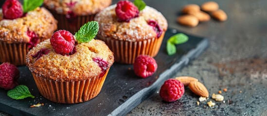 Wholemeal muffins with raspberry almond and a light low fat composition presented beautifully on a copy space image