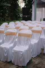 The guest chairs from the wedding party are neatly lined up to create a pattern.