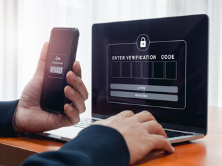 2FA or two factor authentication, cyber security concept. Empty password box for enter verification code show on laptop screen while businessperson man hold smartphone and got passcode key for secure.