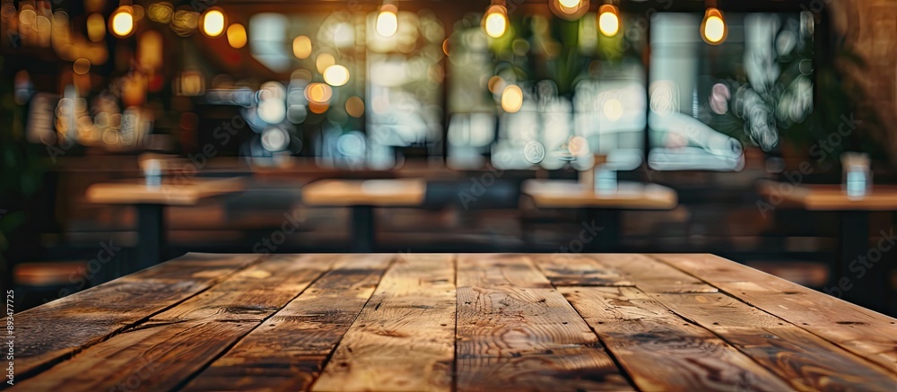 Poster wooden table ideal for showcasing items with a blurred coffee shop or bar setting in the background 