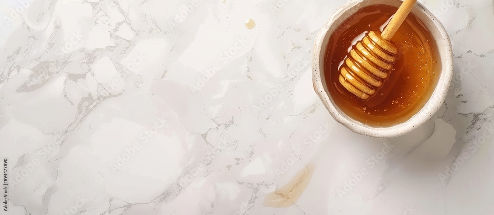 Poster A delicious honey jar with a wooden honey dipper placed on a white surface captured from above with room around for text in the image. copy space available