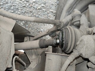 Broken CV joint on the car. CV joint casing burst and lubricant flows.