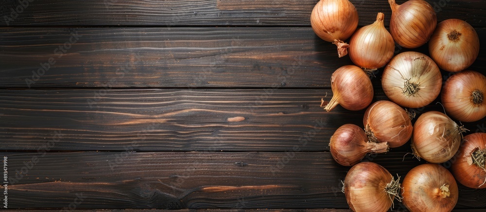 Poster Black wooden table background displaying onions with copy space image