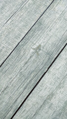 Weathered timber. Wood texture diagonal grey. Wooden texture planks in diagonal order. Grey wooden texture wallpaper background