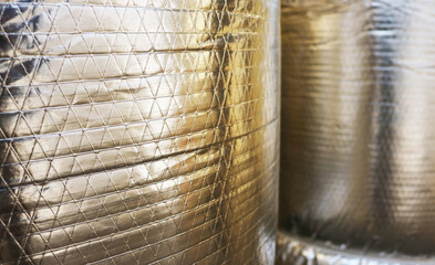 Close-up aluminium foil insulation roll pattern background.