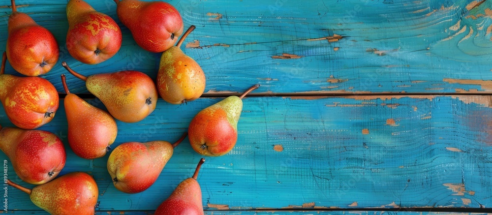Poster ripe conference pears on a vibrant blue wooden background for an autumn harvest with space for text 