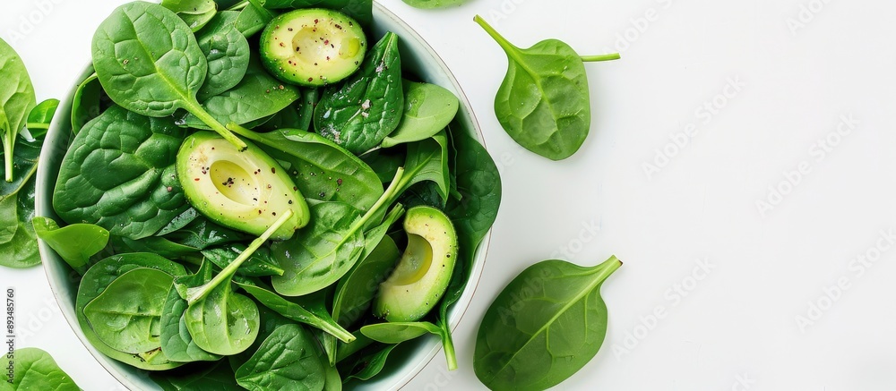 Poster a vegan healthy avocado and spinach salad is set against a white background with ample copy space im
