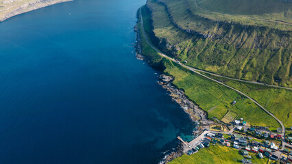 Funningur village, Faroe Islands. Sunny day in summer. Amazing nature in Faroe Islands. Eysturoy Island. Gonguturur or Hvithamar Trailhead. Faroese fjord and summits