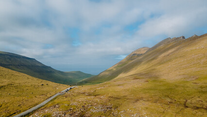 Funningur village, Faroe Islands. Sunny day in summer. Amazing nature in Faroe Islands. Eysturoy Island. Gonguturur or Hvithamar Trailhead. Faroese fjord and summits