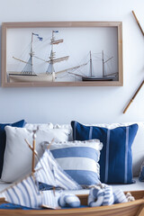 Nautical-themed Living Room Decor with Model Ships and Blue Cushions
